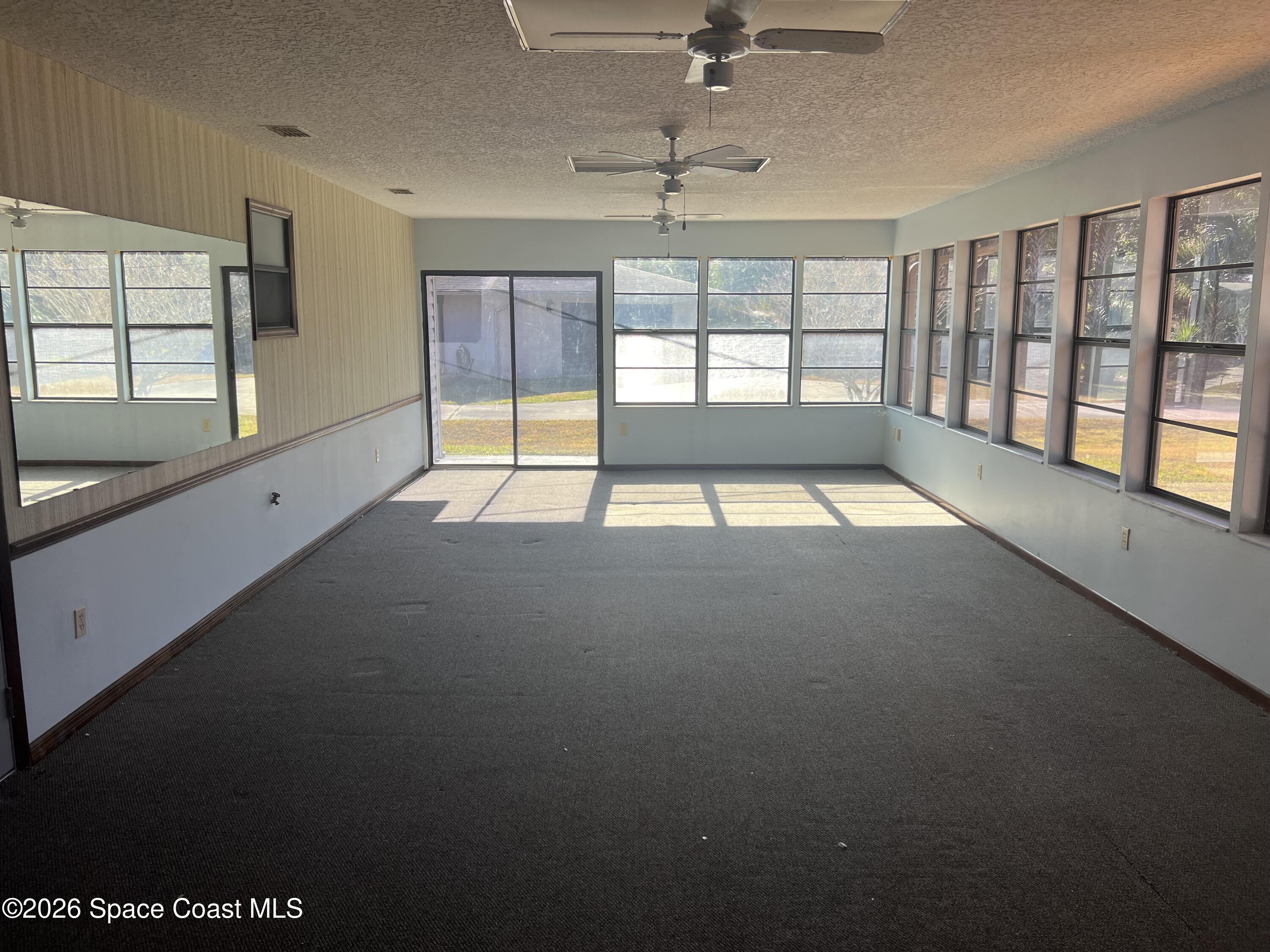 1766 Sand Road Southeast Palm Bay, FL 32909 - Photo 9 of 13 a view of an empty room with a window