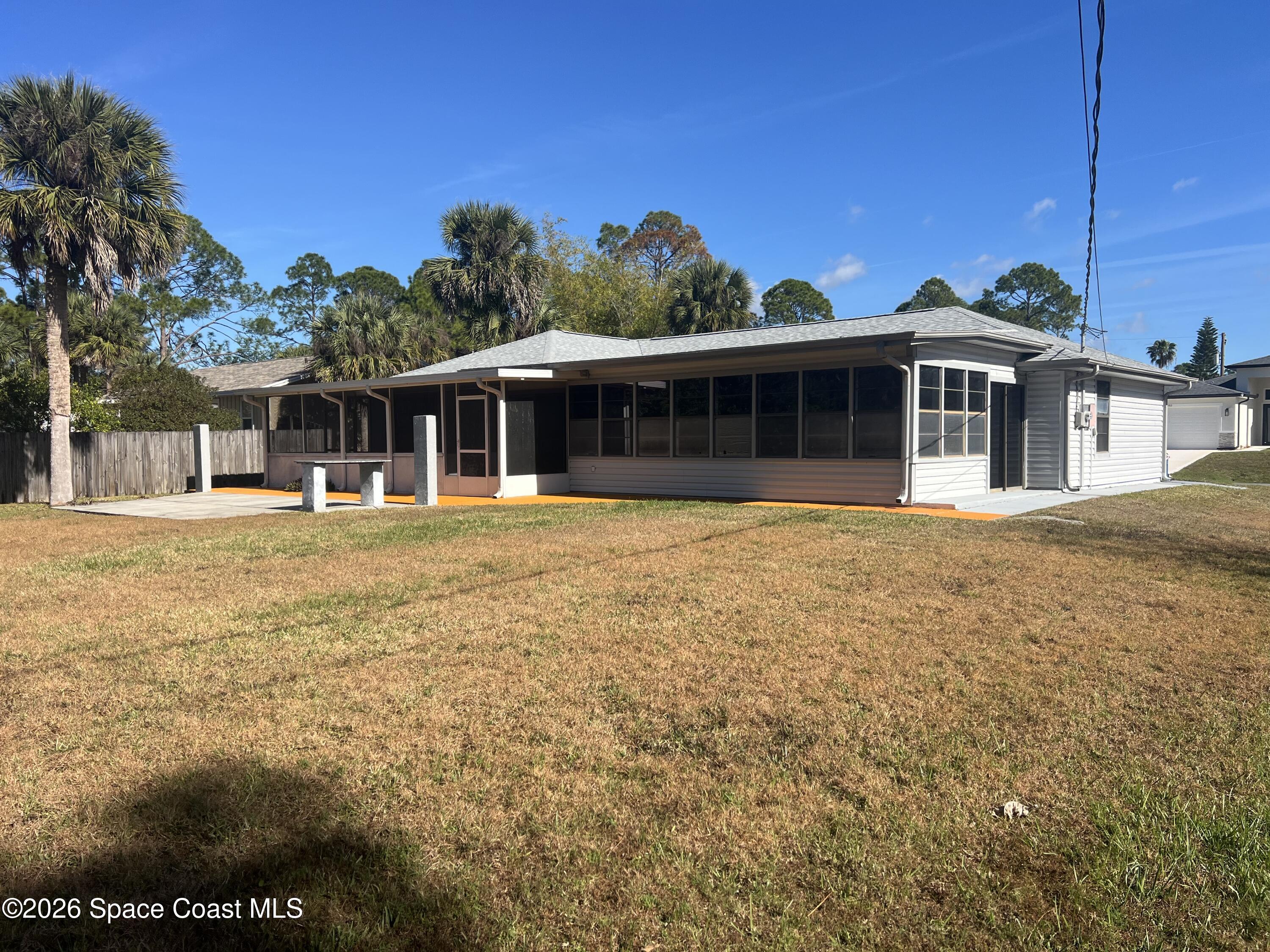 1766 Sand Road Southeast Palm Bay, FL 32909 - Photo 10 of 13 a front view of a house with a yard