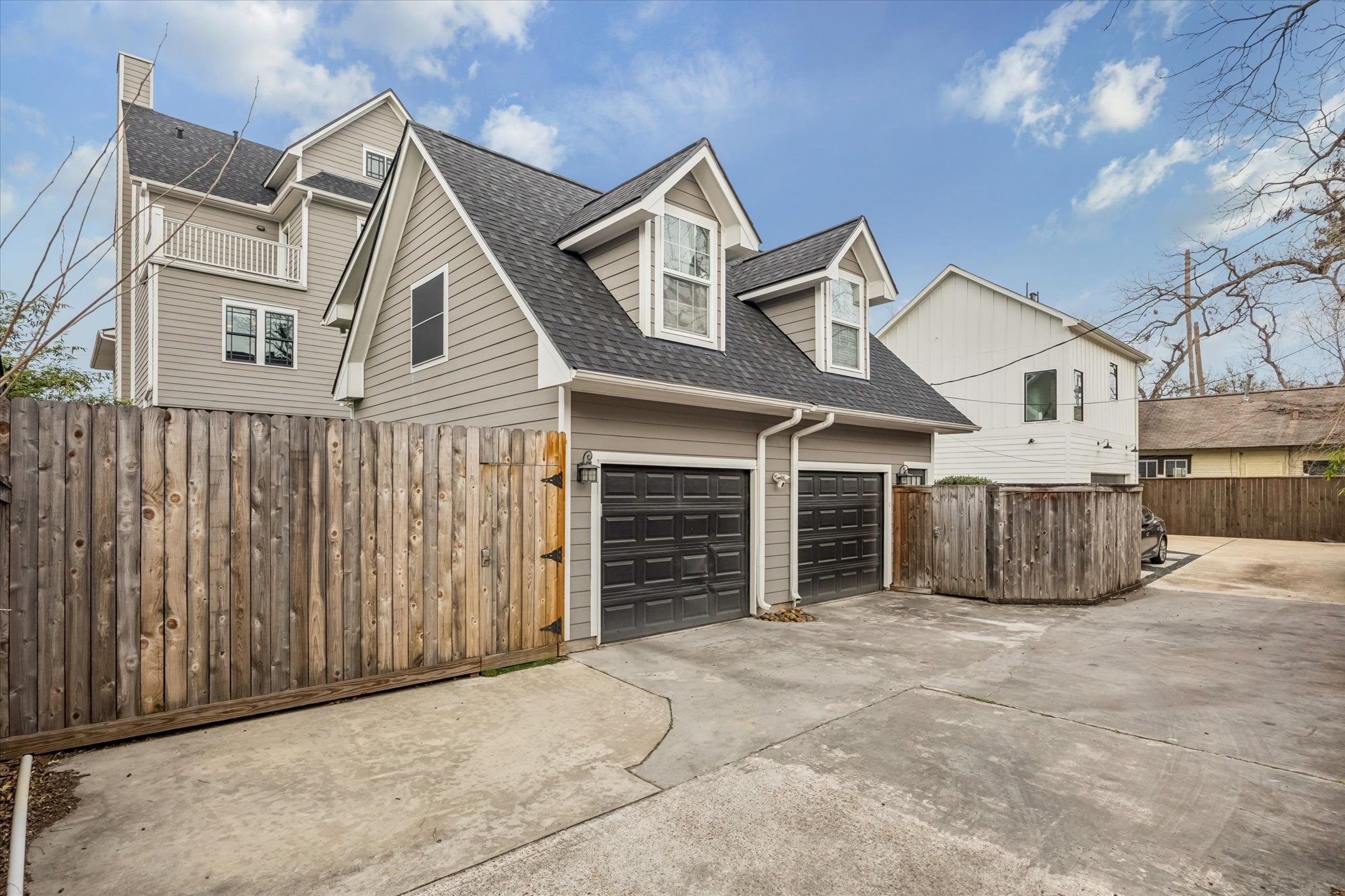 610 East 7th Street Houston, TX 77007 - Photo 39 of 40 OVERSIZED TWO CAR GARAGE, IDEALLY SITUATED NEAR THE DEAD END OF THE ALLEYWAY AND FEATURES AN ADDITIONAL PARKING PAD ALONG THE FENCELINE.