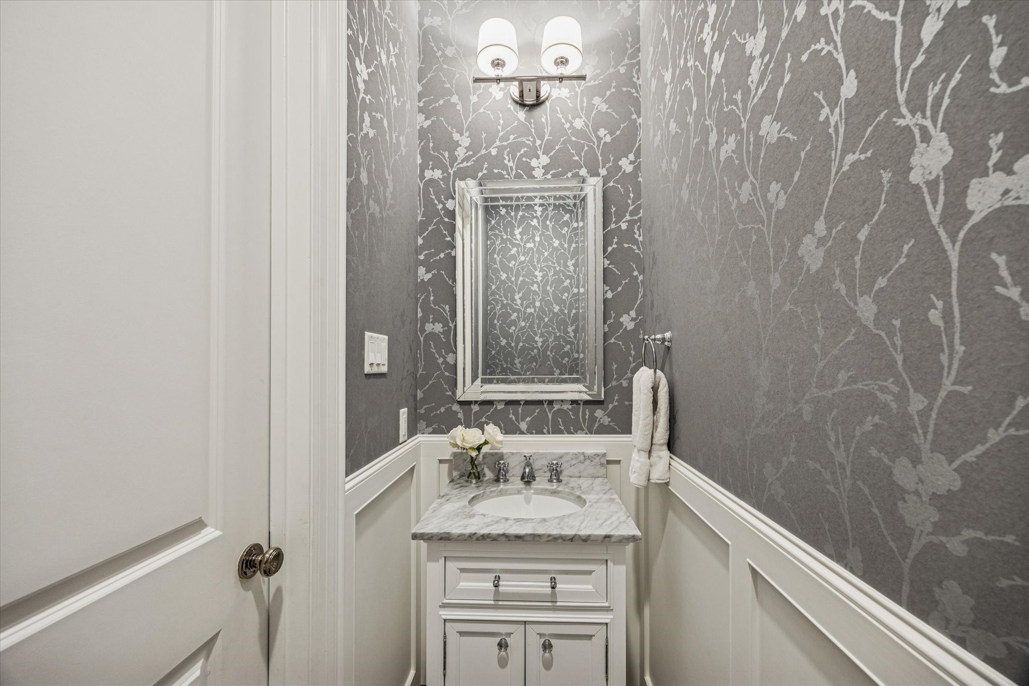 610 East 7th Street Houston, TX 77007 - Photo 5 of 40 DOWNSTAIRS POWDER BATHROOM WITH PANEL DETAIL, DESIGNER WALLPAPER AND MARBLE COUNTERTOP.
