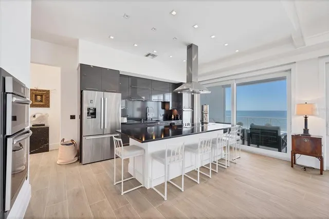 a kitchen with stainless steel appliances a sink and cabinets