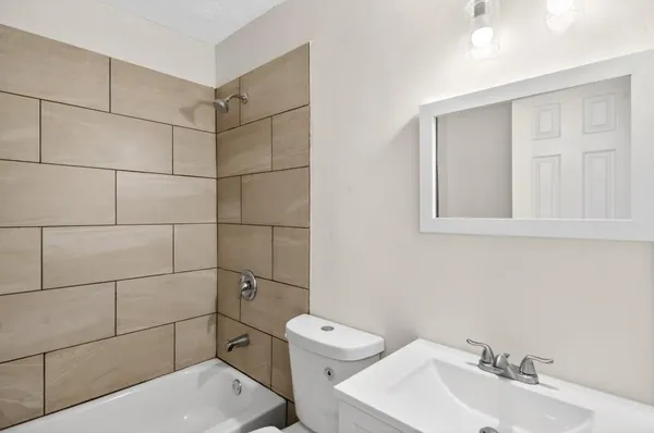 a bathroom with a toilet sink and shower