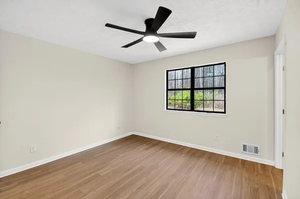 wooden floor in an empty room with a window
