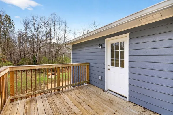 a balcony with wooden floor and fence