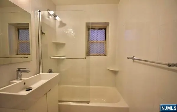 a bathroom with a bathtub and a sink