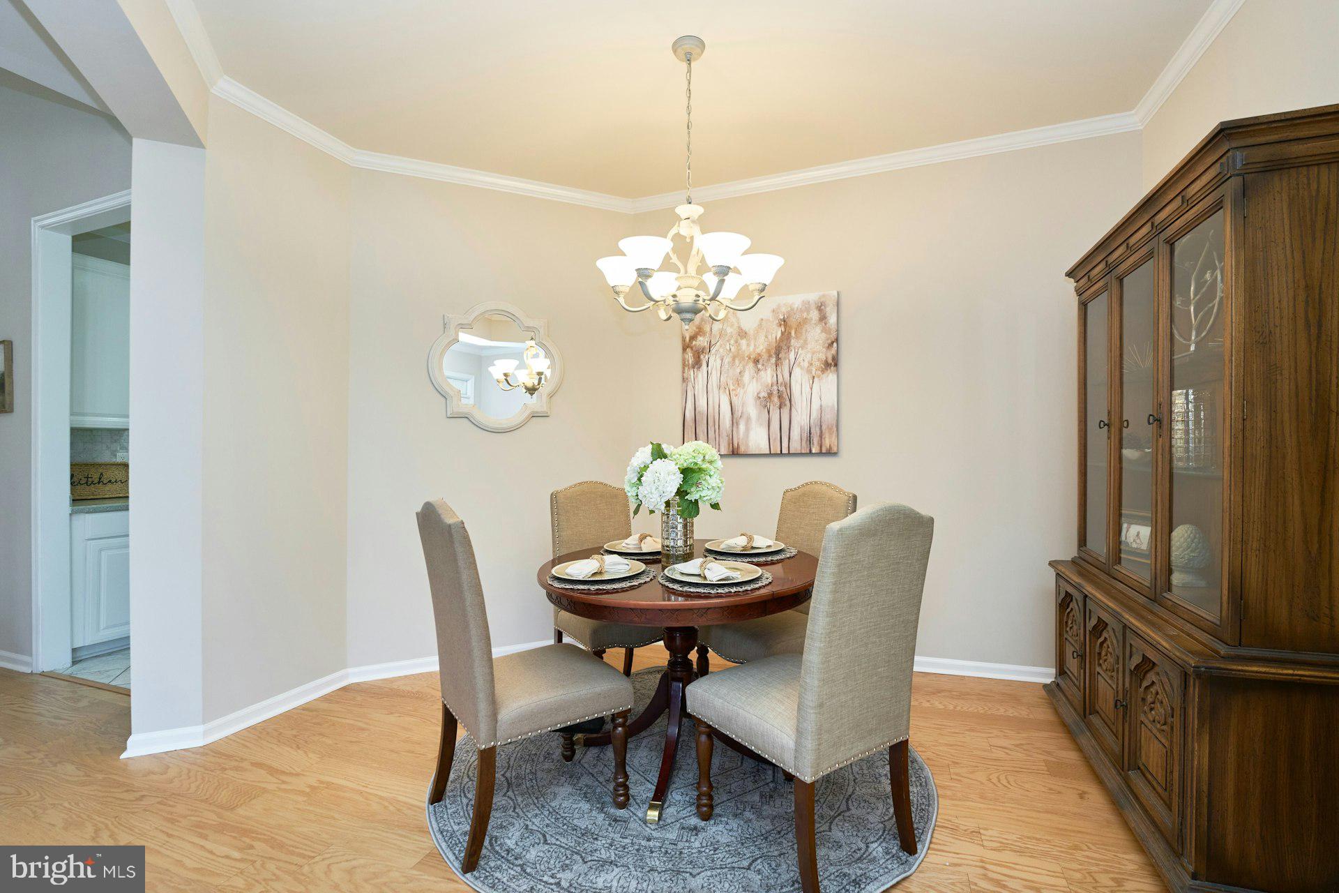 6916 Broadleaf Terrace Gainesville, VA 20155 - Photo 6 of 40 Dining Room with Chandelier, Crown Molding