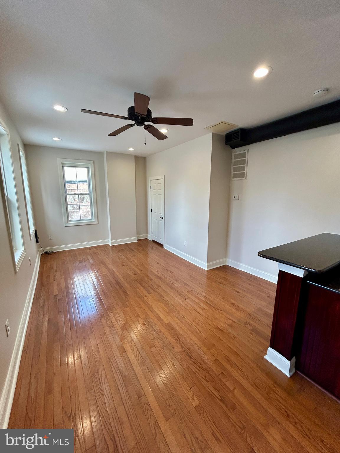 101 Fayette Street, Unit 2 Conshohocken, PA 19428 - Photo 1 of 19 a view of an empty room with wooden floor and a ceiling fan