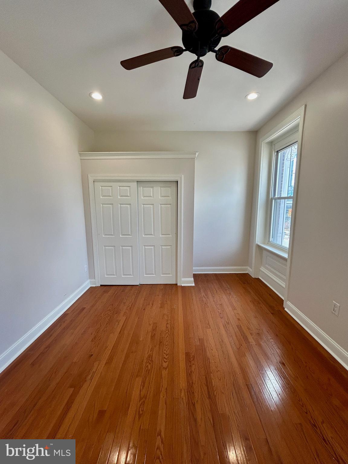 101 Fayette Street, Unit 2 Conshohocken, PA 19428 - Photo 15 of 19 an empty room with wooden floor and windows