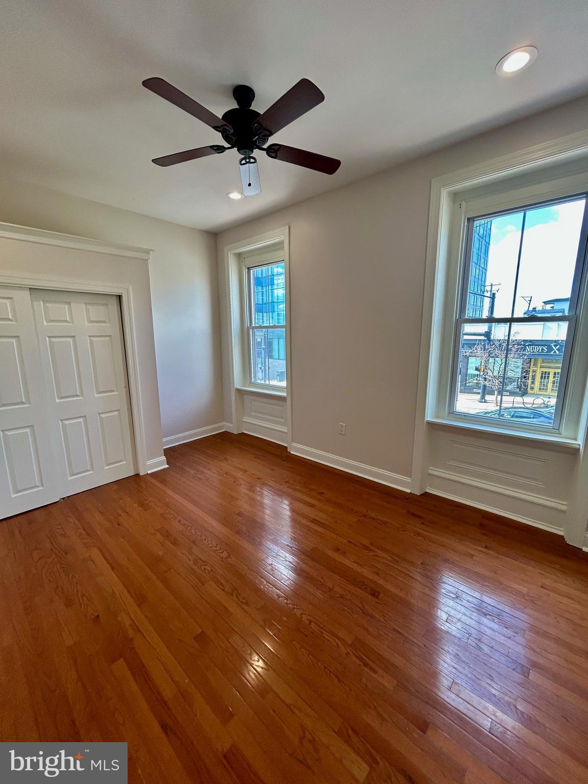 101 Fayette Street, Unit 2 Conshohocken, PA 19428 - Photo 16 of 19 a view of an empty room with wooden floor and a window