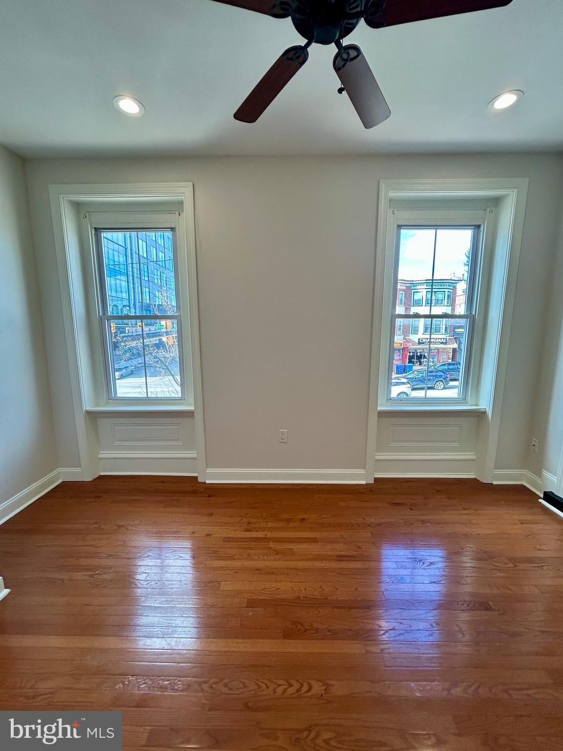 101 Fayette Street, Unit 2 Conshohocken, PA 19428 - Photo 17 of 19 a view of an empty room with wooden floor and a window