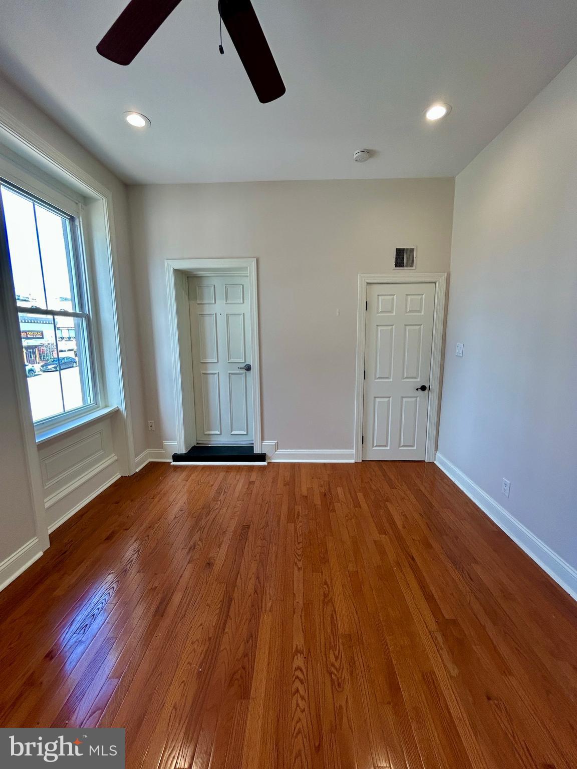 101 Fayette Street, Unit 2 Conshohocken, PA 19428 - Photo 18 of 19 an empty room with wooden floor and windows
