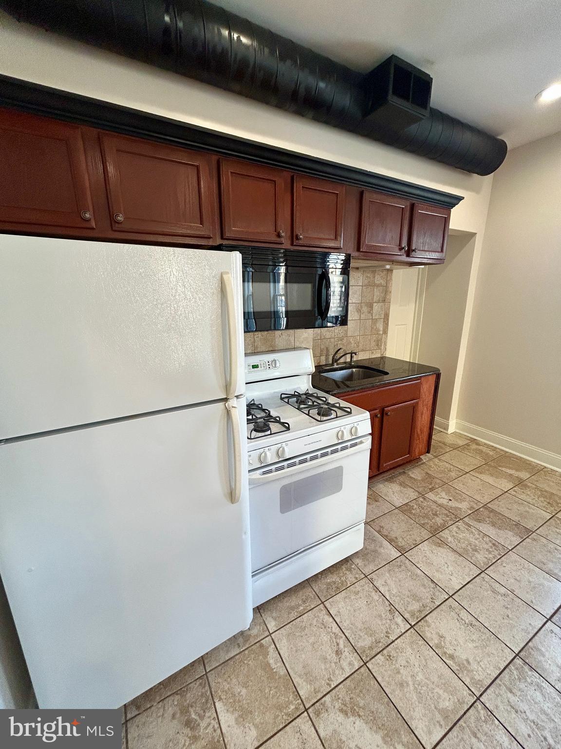 101 Fayette Street, Unit 2 Conshohocken, PA 19428 - Photo 6 of 19 a kitchen with stainless steel appliances granite countertop a refrigerator and a stove