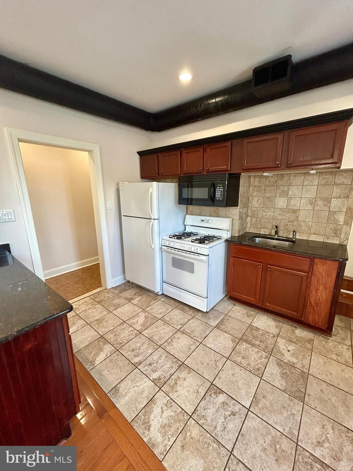 101 Fayette Street, Unit 2 Conshohocken, PA 19428 - Photo 7 of 19 a kitchen with stainless steel appliances granite countertop a sink stove and cabinets