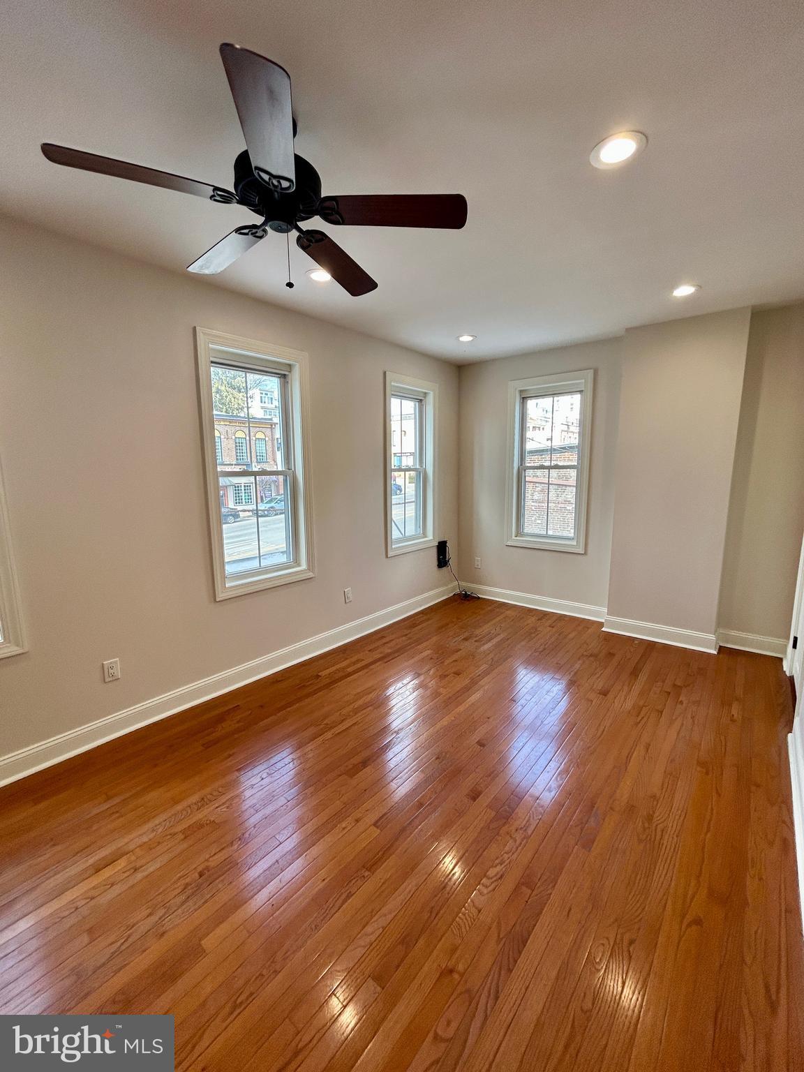 101 Fayette Street, Unit 2 Conshohocken, PA 19428 - Photo 10 of 19 a view of an empty room with wooden floor and a window