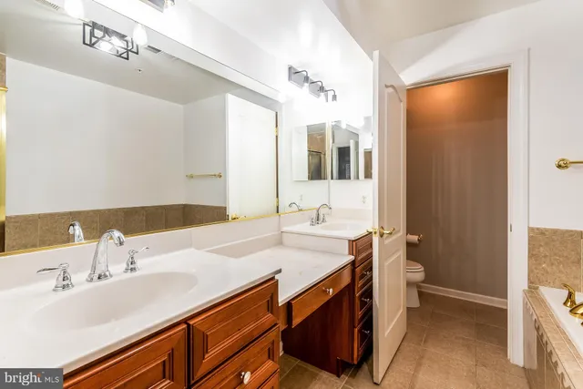 a bathroom with a sink double vanity and a mirror