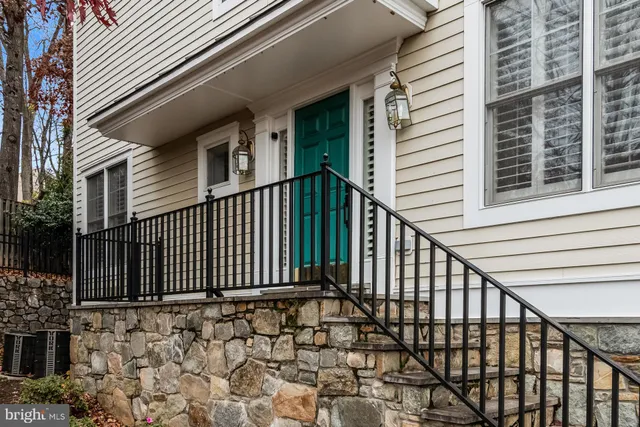 a view of staircase with a white door