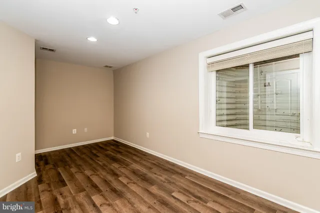 a view of a room with wooden floor and window