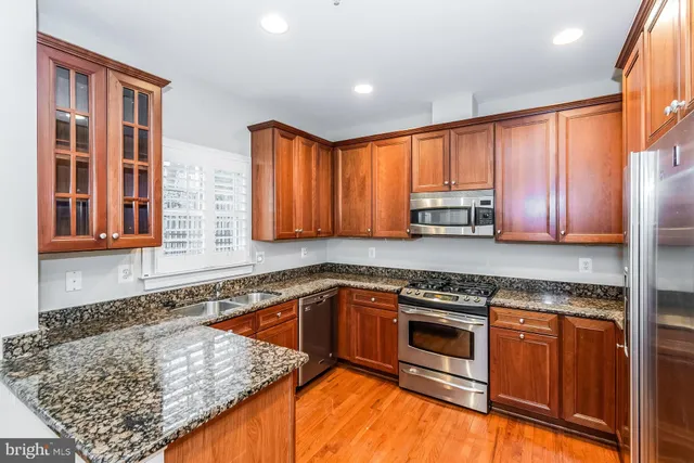 a kitchen with a stove a sink and a microwave