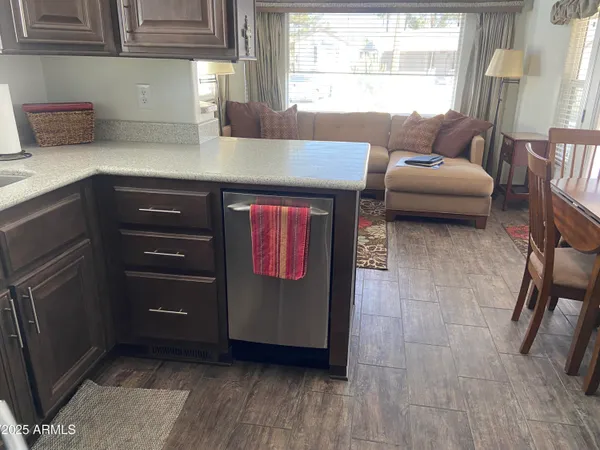 a kitchen with stainless steel appliances granite countertop a sink and wooden cabinets