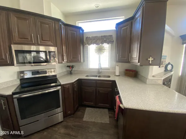 a kitchen with a stove a sink and a microwave