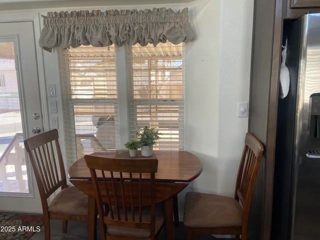 a view of a dining room with furniture window and outside view