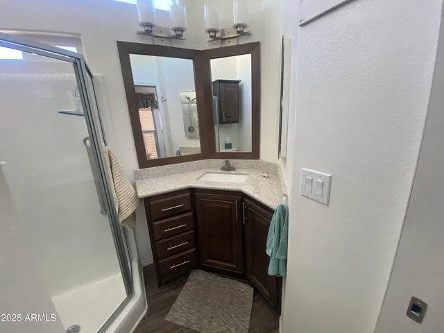a bathroom with a sink a mirror and vanity