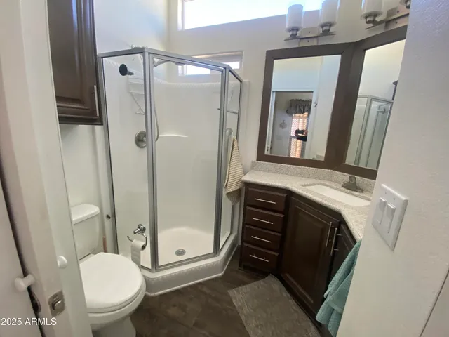 a bathroom with a toilet a sink and shower