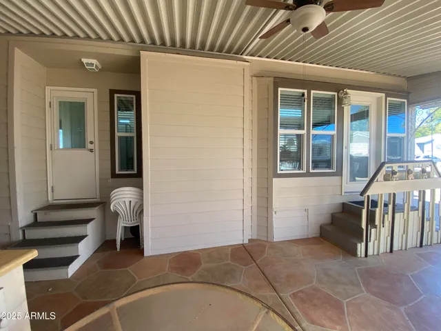 a view of a livingroom with furniture and staircase