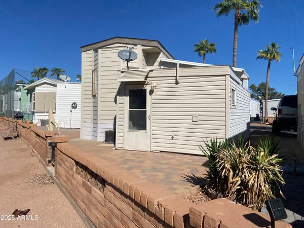 a view of a backyard with plants and a patio