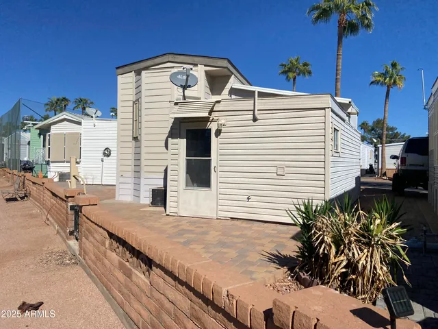 a view of a backyard with plants and a patio