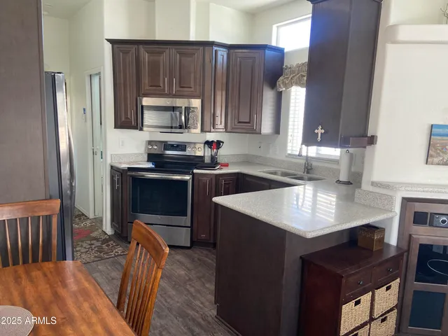 a kitchen with a sink a stove a microwave and refrigerator