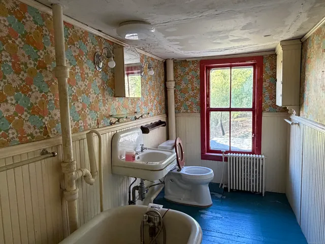 a bathroom with a tub toilet sink and mirror