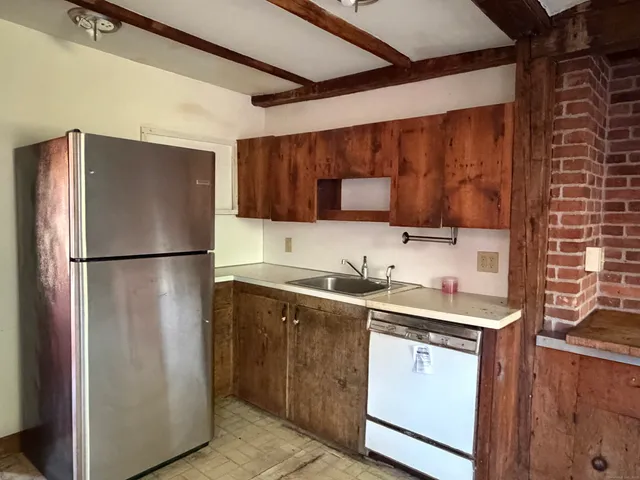 a kitchen with stainless steel appliances granite countertop a refrigerator a sink and a stove