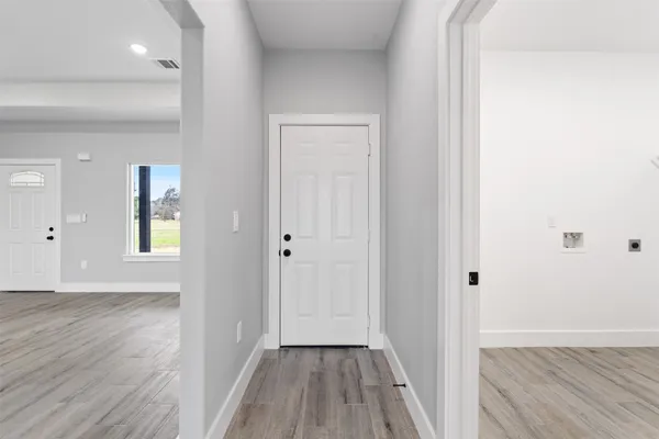 a view of a hallway with wooden floor