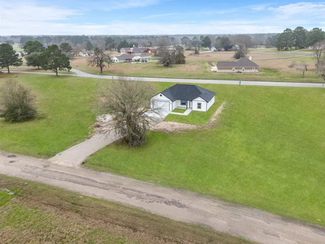 an aerial view of a houses with outdoor space and lake view