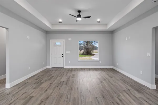 wooden floor in an empty room with a window