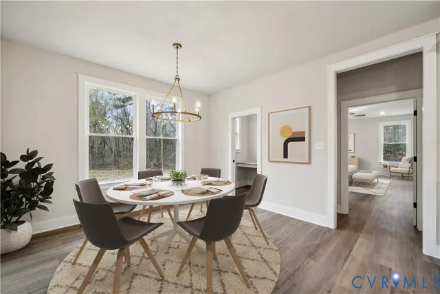 a large kitchen with kitchen island a stove a sink a center island and wooden floor