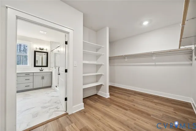 a spacious bathroom with double sink and a shower