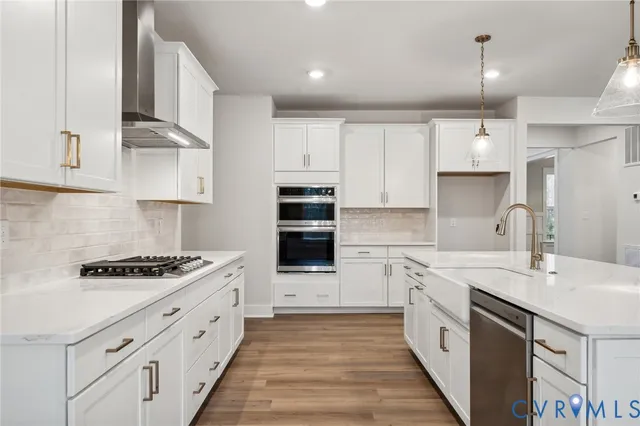 a kitchen with kitchen island a sink stainless steel appliances and cabinets