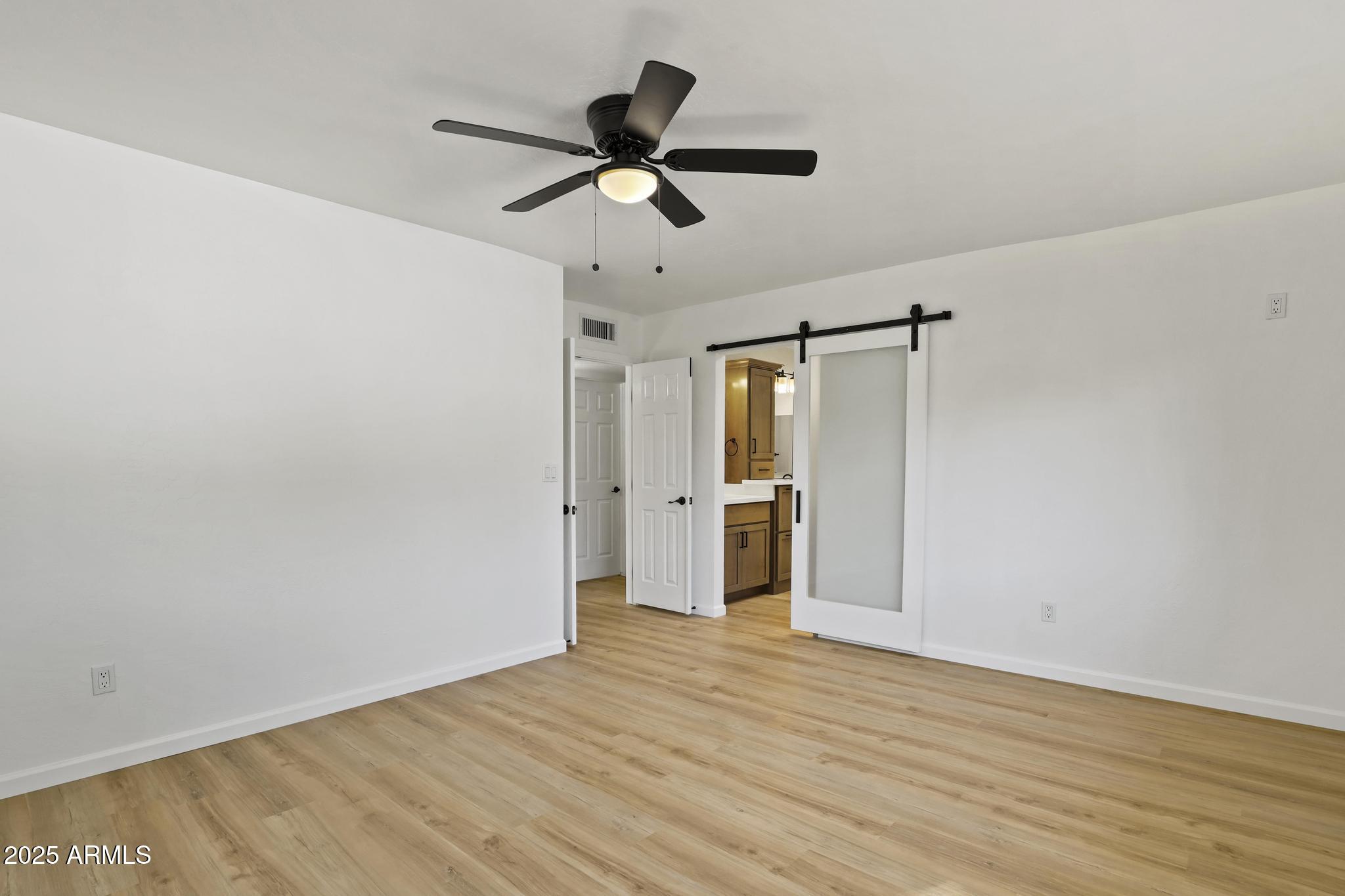 625 East Coronado Way Payson, AZ 85541 - Photo 11 of 25 a view of a big room with wooden floor a ceiling fan and staircase