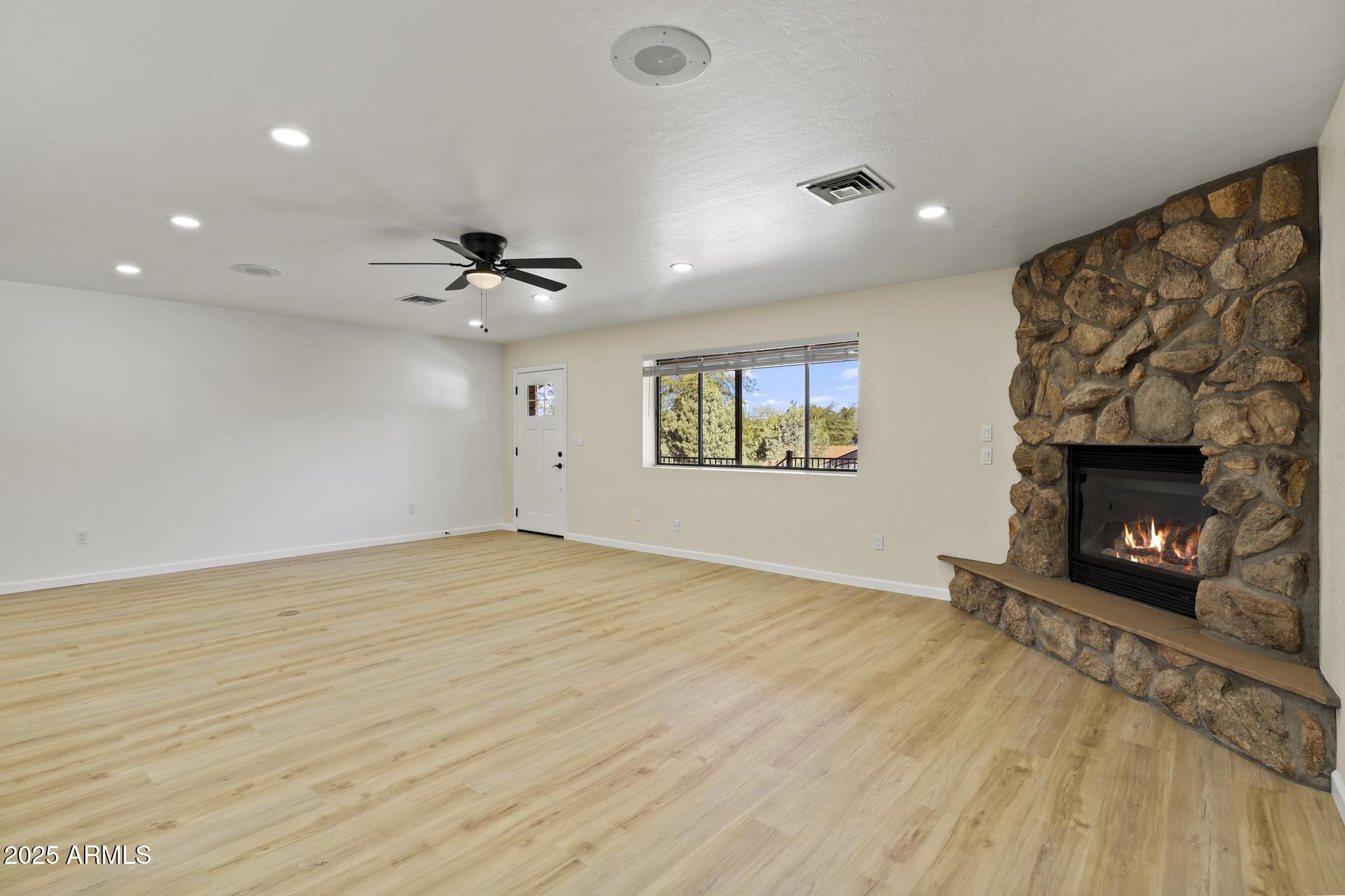625 East Coronado Way Payson, AZ 85541 - Photo 7 of 25 a view of an empty room with a fireplace and a window