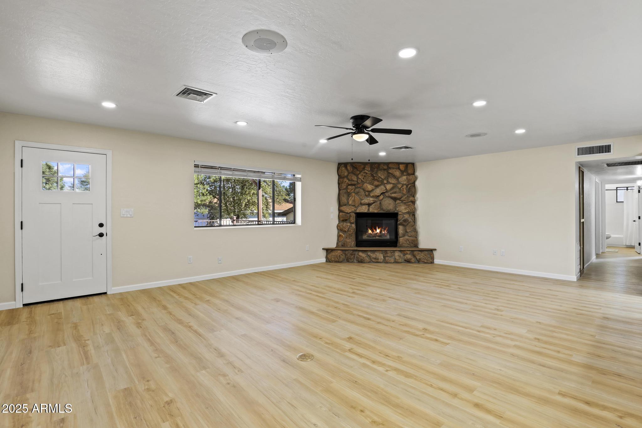 625 East Coronado Way Payson, AZ 85541 - Photo 8 of 25 an empty room with wooden floor a ceiling fan and windows