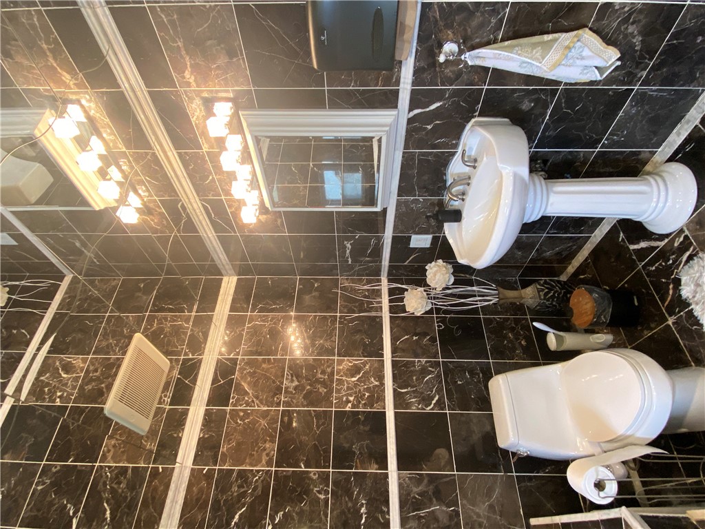 175 Rita Street Dayton, OH 45404 - Photo 20 of 48 This bathroom features elegant tile flooring and a classic pedestal sink, offering a refined aesthetic.