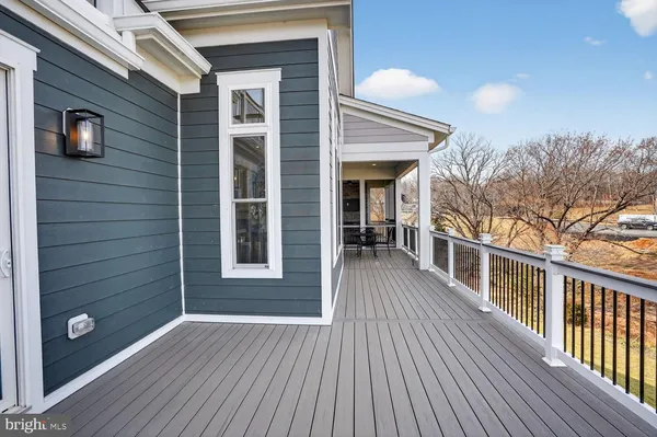 a large kitchen with stainless steel appliances a stove oven and a large refrigerator with wooden floor