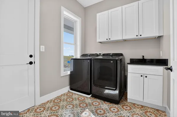 a kitchen with stainless steel appliances a sink and cabinets