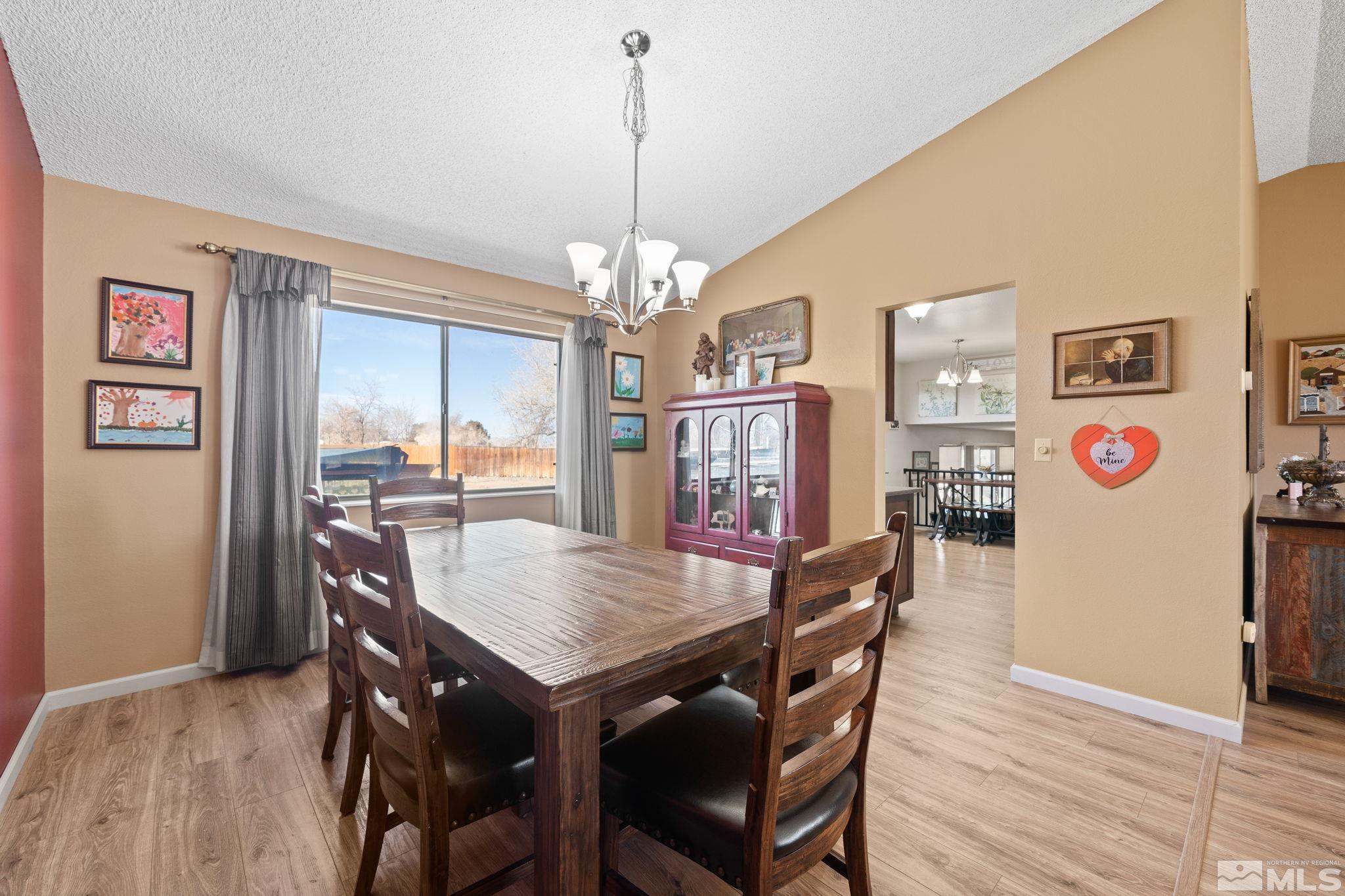1629 Tumbleweed Road Fallon, NV 89406 - Photo 11 of 39 a view of a dining room with furniture and wooden floor