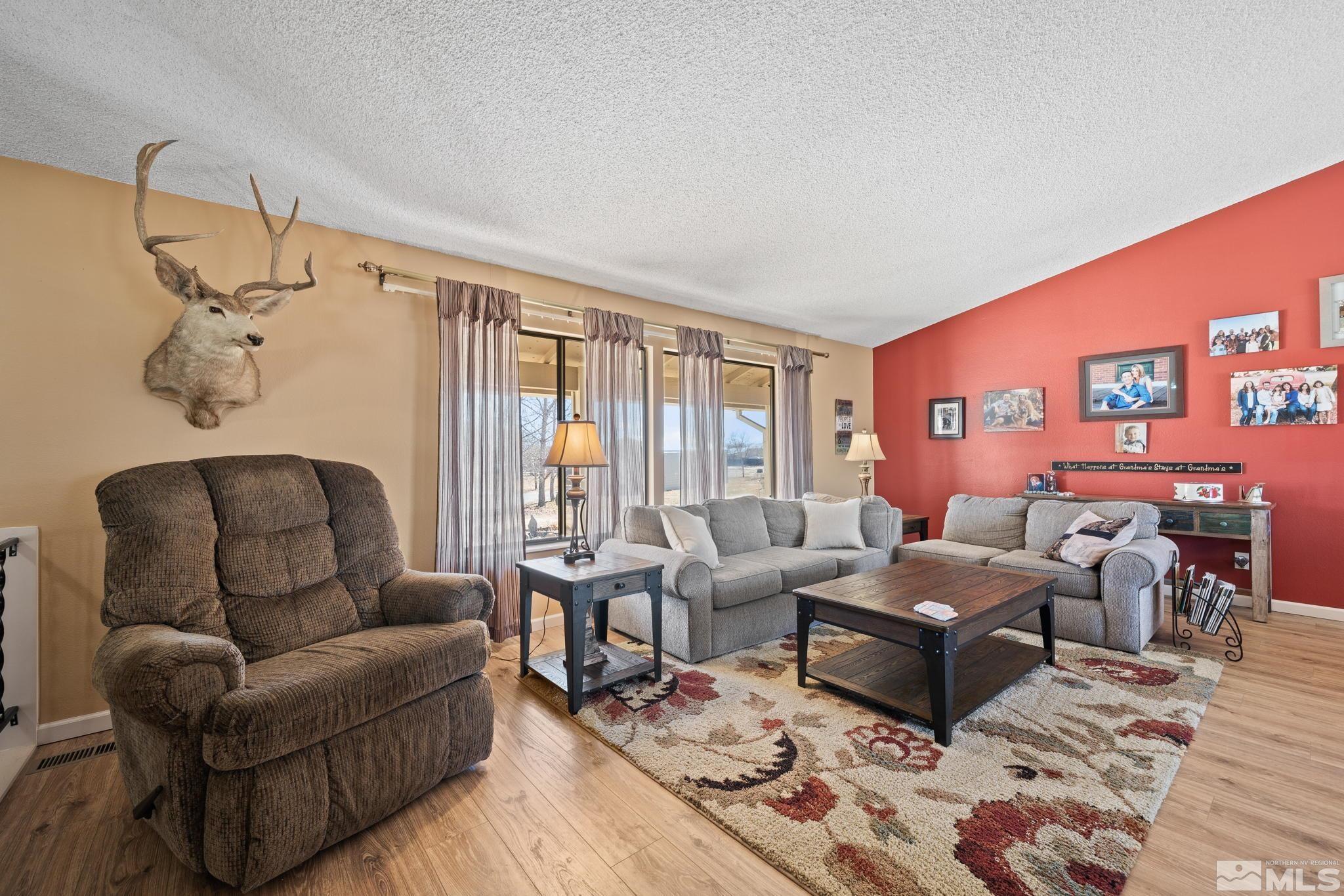 1629 Tumbleweed Road Fallon, NV 89406 - Photo 7 of 39 a living room with furniture wooden floor and a large window