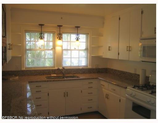 312 Sunset Road West Palm Beach, FL 33401 - Photo 4 of 8 a kitchen with granite countertop a sink window and cabinets