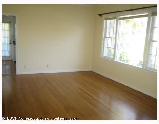 312 Sunset Road West Palm Beach, FL 33401 - Photo 5 of 8 an empty room with wooden floor and windows