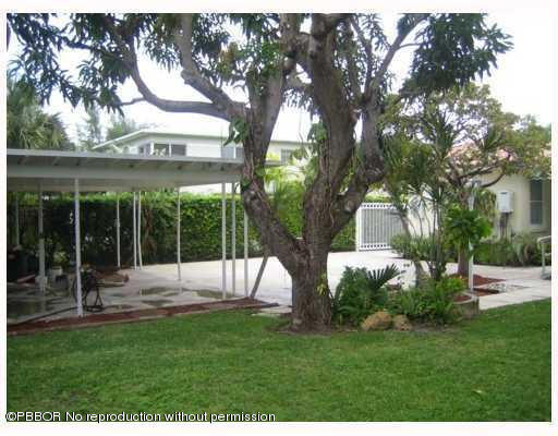 312 Sunset Road West Palm Beach, FL 33401 - Photo 8 of 8 a view of a house with a backyard porch and sitting area